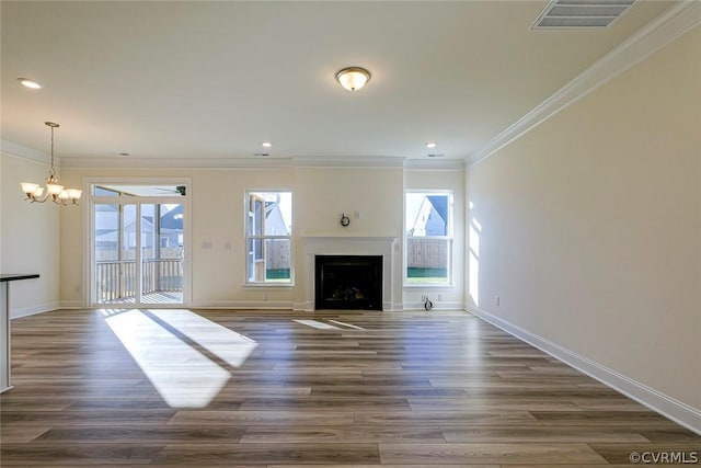 unfurnished living room with crown molding, dark hardwood / wood-style floors, and an inviting chandelier