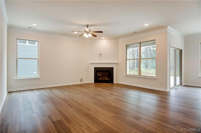 unfurnished living room featuring crown molding, dark wood-type flooring, and ceiling fan