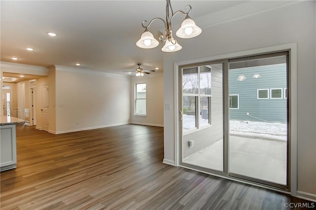 entryway featuring crown molding, dark hardwood / wood-style floors, and ceiling fan with notable chandelier