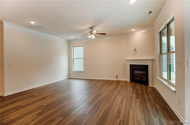 unfurnished living room featuring ornamental molding, dark hardwood / wood-style floors, and a healthy amount of sunlight