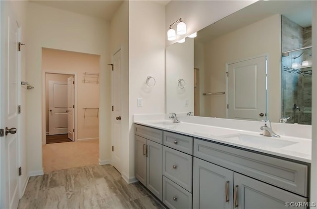 bathroom with walk in shower and vanity