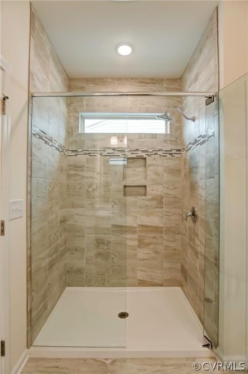 bathroom featuring a healthy amount of sunlight and an enclosed shower