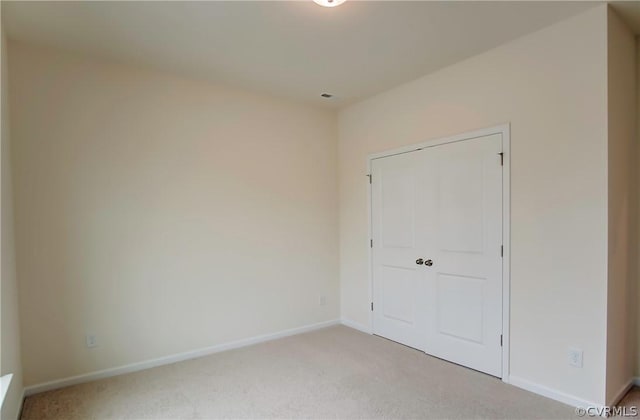 unfurnished bedroom featuring light carpet