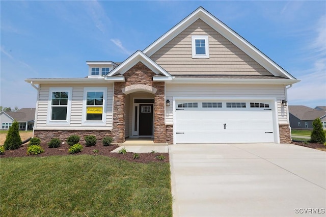 craftsman-style home with stone siding, driveway, and a front yard