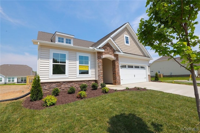 view of front of house featuring stone siding, concrete driveway, a front yard, and a shingled roof