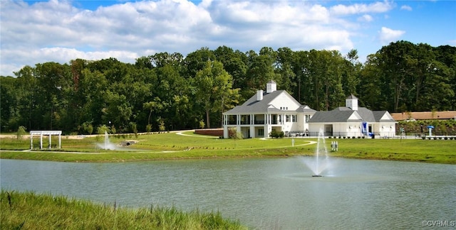 water view featuring fence and a heavily wooded area
