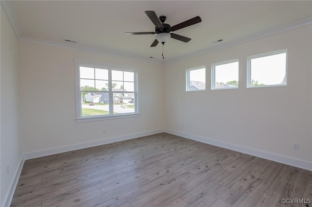 spare room featuring ornamental molding, light wood finished floors, baseboards, and ceiling fan