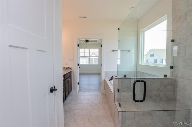 full bath featuring a garden tub, a shower stall, vanity, a ceiling fan, and tile patterned flooring