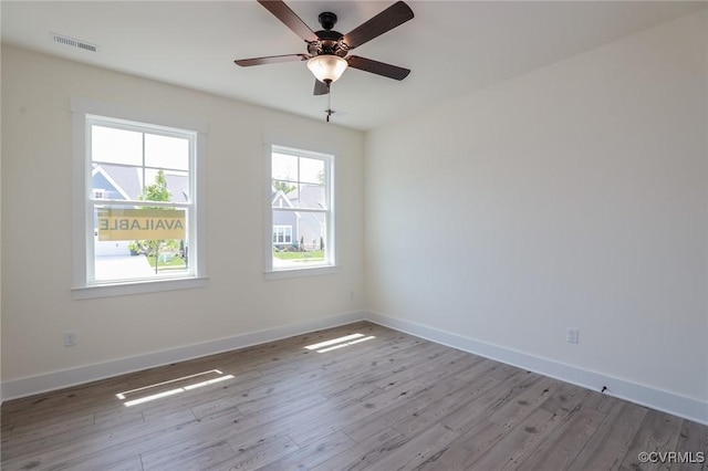 spare room with wood finished floors, baseboards, and ceiling fan