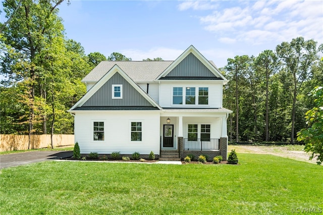 craftsman-style house with covered porch and a front lawn