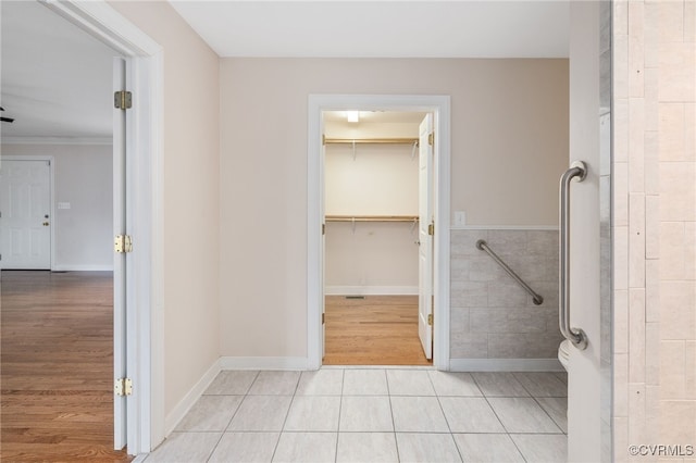 bathroom with hardwood / wood-style flooring and crown molding