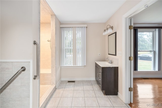 bathroom featuring hardwood / wood-style floors, vanity, and walk in shower