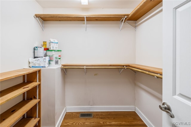 spacious closet with hardwood / wood-style flooring