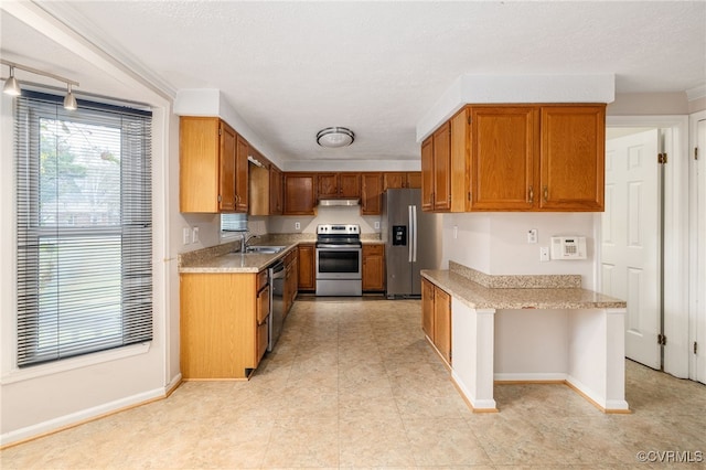 kitchen featuring sink, stainless steel appliances, and a textured ceiling