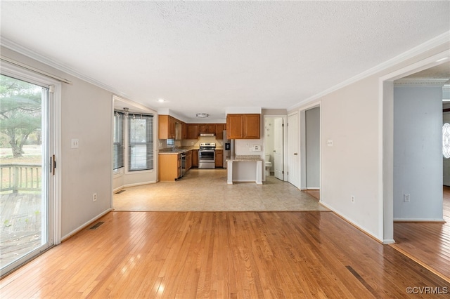 unfurnished living room featuring crown molding, sink, a textured ceiling, and light wood-type flooring