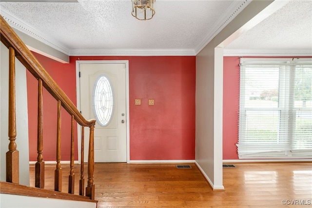 foyer with a wealth of natural light, hardwood / wood-style floors, and a textured ceiling