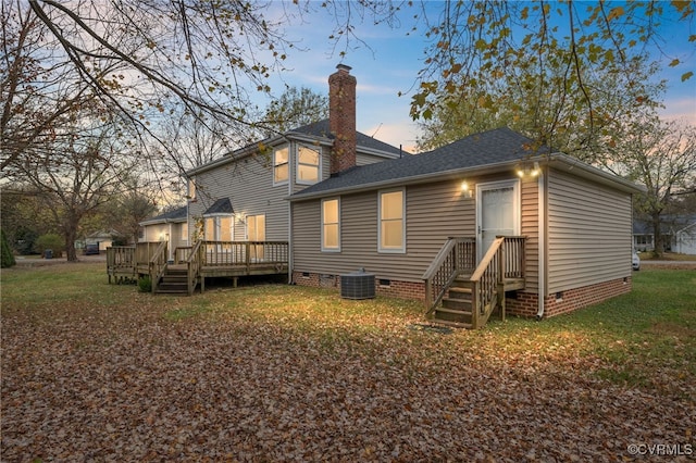 back house at dusk featuring a deck and central air condition unit