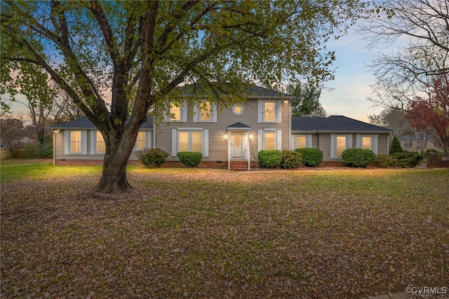 colonial home featuring a yard