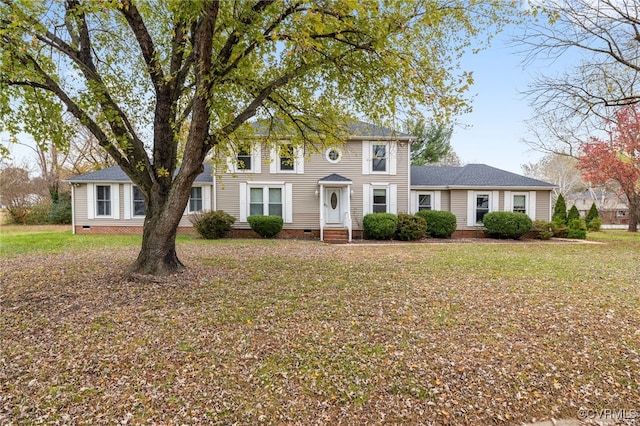 colonial-style house featuring a front lawn