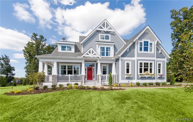 craftsman house featuring a porch and a front lawn