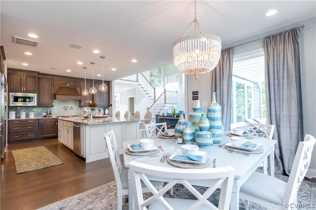 dining space featuring a chandelier and dark hardwood / wood-style floors