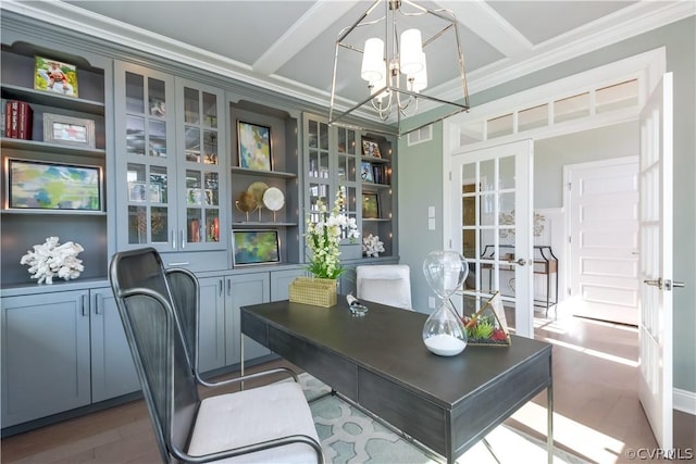 office space featuring beamed ceiling, ornamental molding, coffered ceiling, and a notable chandelier