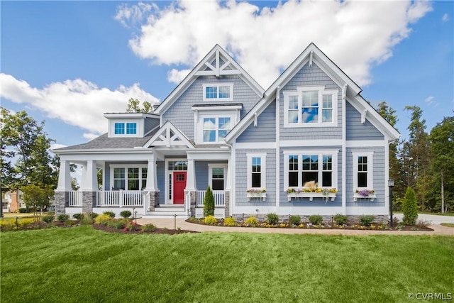 craftsman inspired home featuring a porch and a front yard