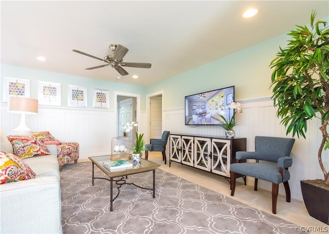 living room featuring ceiling fan and carpet