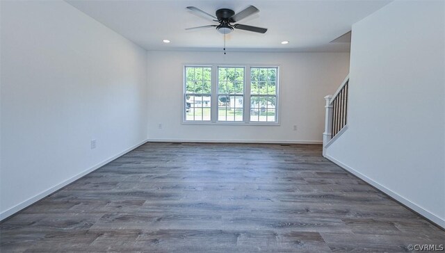 empty room featuring ceiling fan and dark wood-type flooring