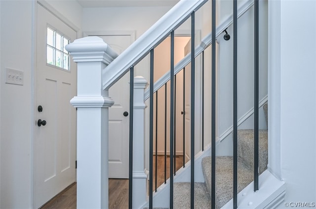 stairs with hardwood / wood-style floors