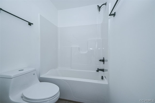 bathroom featuring shower / tub combination and toilet