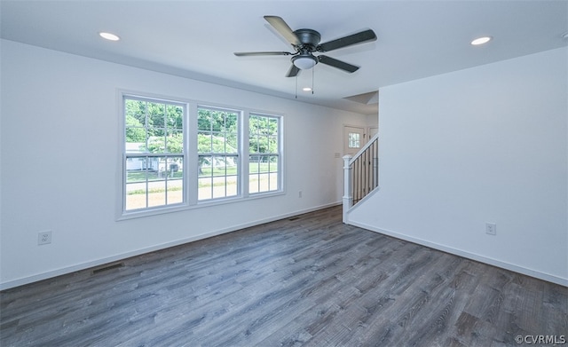 unfurnished room featuring ceiling fan and dark hardwood / wood-style flooring