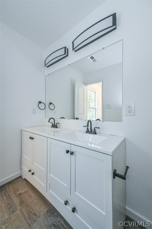 bathroom with vanity and wood-type flooring