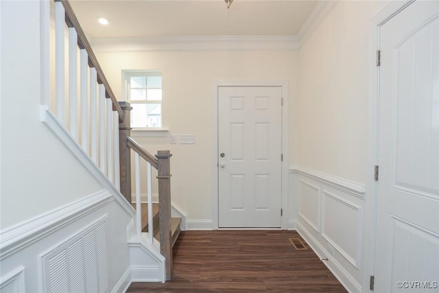 foyer entrance featuring dark hardwood / wood-style flooring and ornamental molding