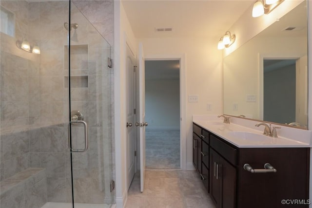 bathroom featuring vanity and a shower with shower door