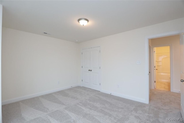 spare room featuring light colored carpet