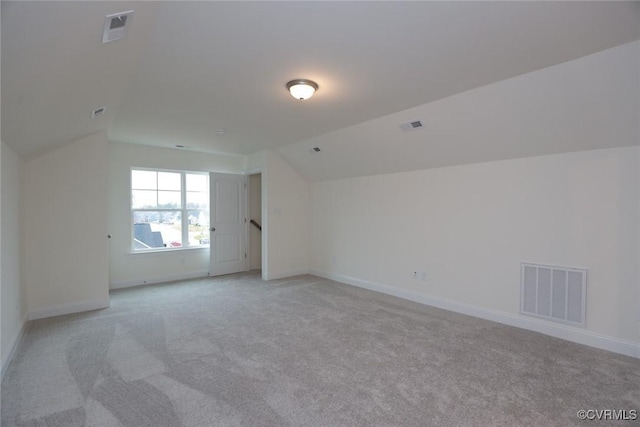 bonus room featuring light colored carpet and vaulted ceiling