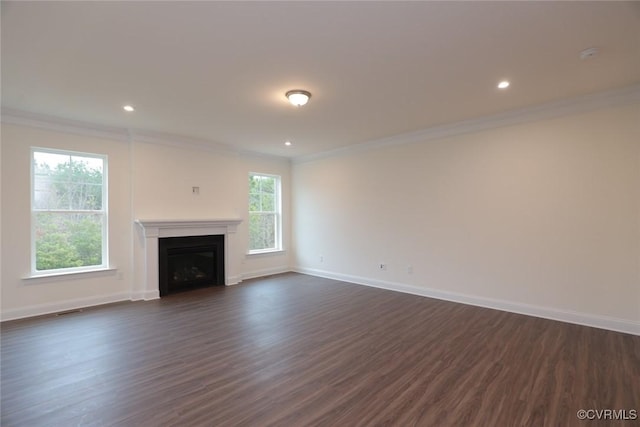 unfurnished living room featuring dark hardwood / wood-style floors and crown molding