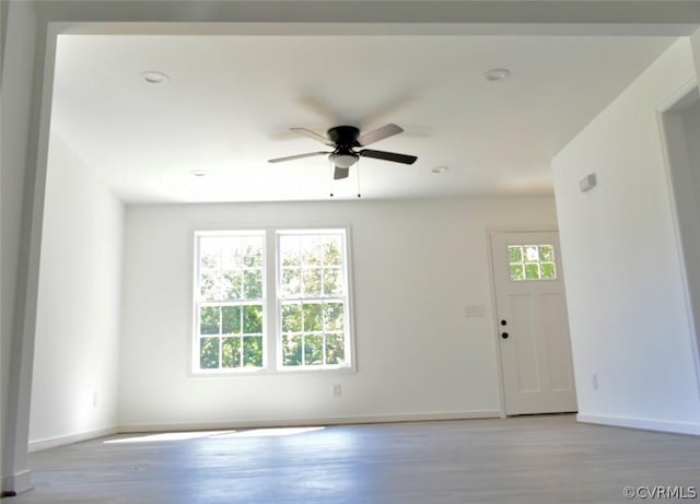 unfurnished room with ceiling fan, plenty of natural light, and light hardwood / wood-style floors