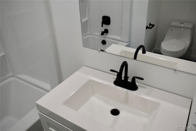 full bathroom featuring shower / tub combination, vanity, and toilet