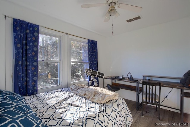 bedroom with ceiling fan and dark wood-type flooring