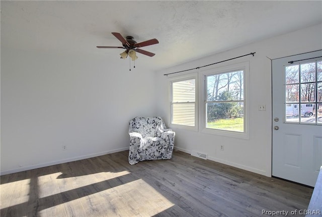 unfurnished room featuring ceiling fan and dark hardwood / wood-style flooring