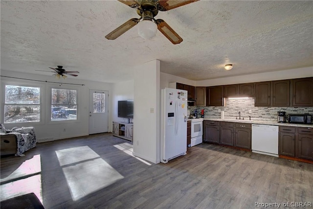 kitchen with white appliances, ceiling fan, tasteful backsplash, dark brown cabinets, and wood-type flooring