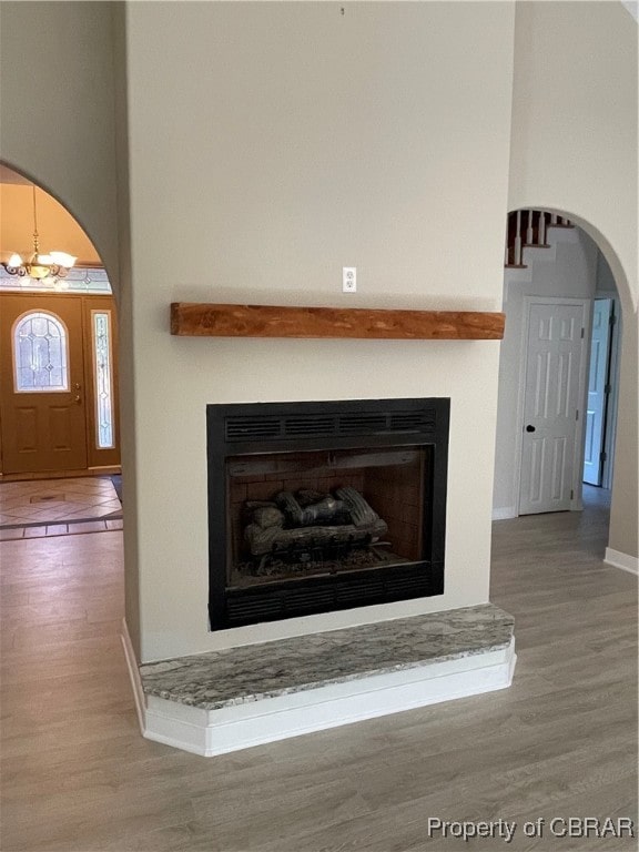 details with a chandelier and hardwood / wood-style floors