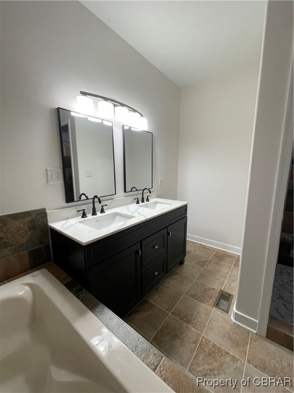 bathroom with a bath and vanity