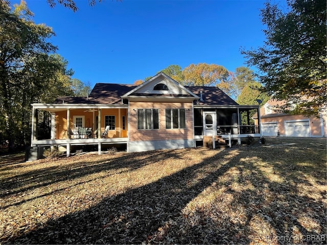 back of house featuring a sunroom and a yard