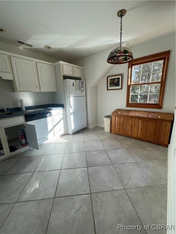 kitchen featuring white cabinetry, light tile patterned flooring, decorative light fixtures, and white appliances