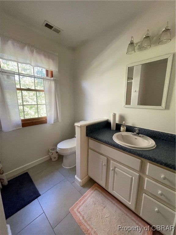 bathroom featuring tile patterned floors, vanity, and toilet