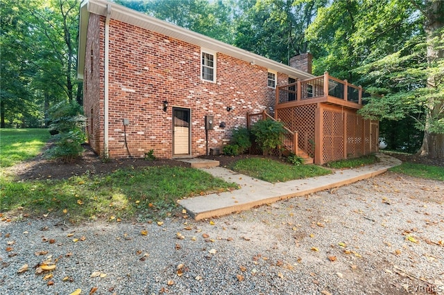 rear view of property featuring a wooden deck