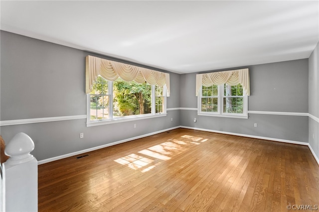 unfurnished room with hardwood / wood-style flooring